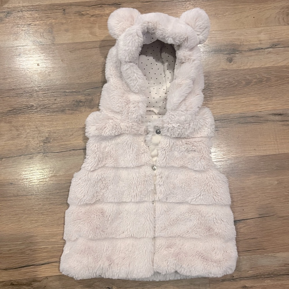 Fuzzy hooded vest with teddy bear ears.